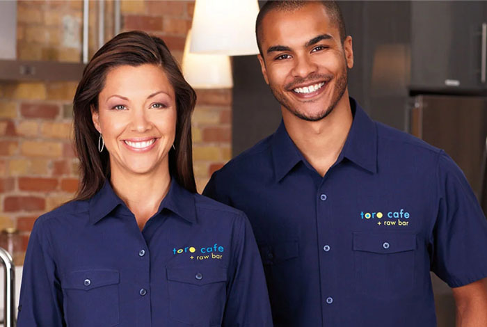 couple with logos on business polos couple with logos on business polos